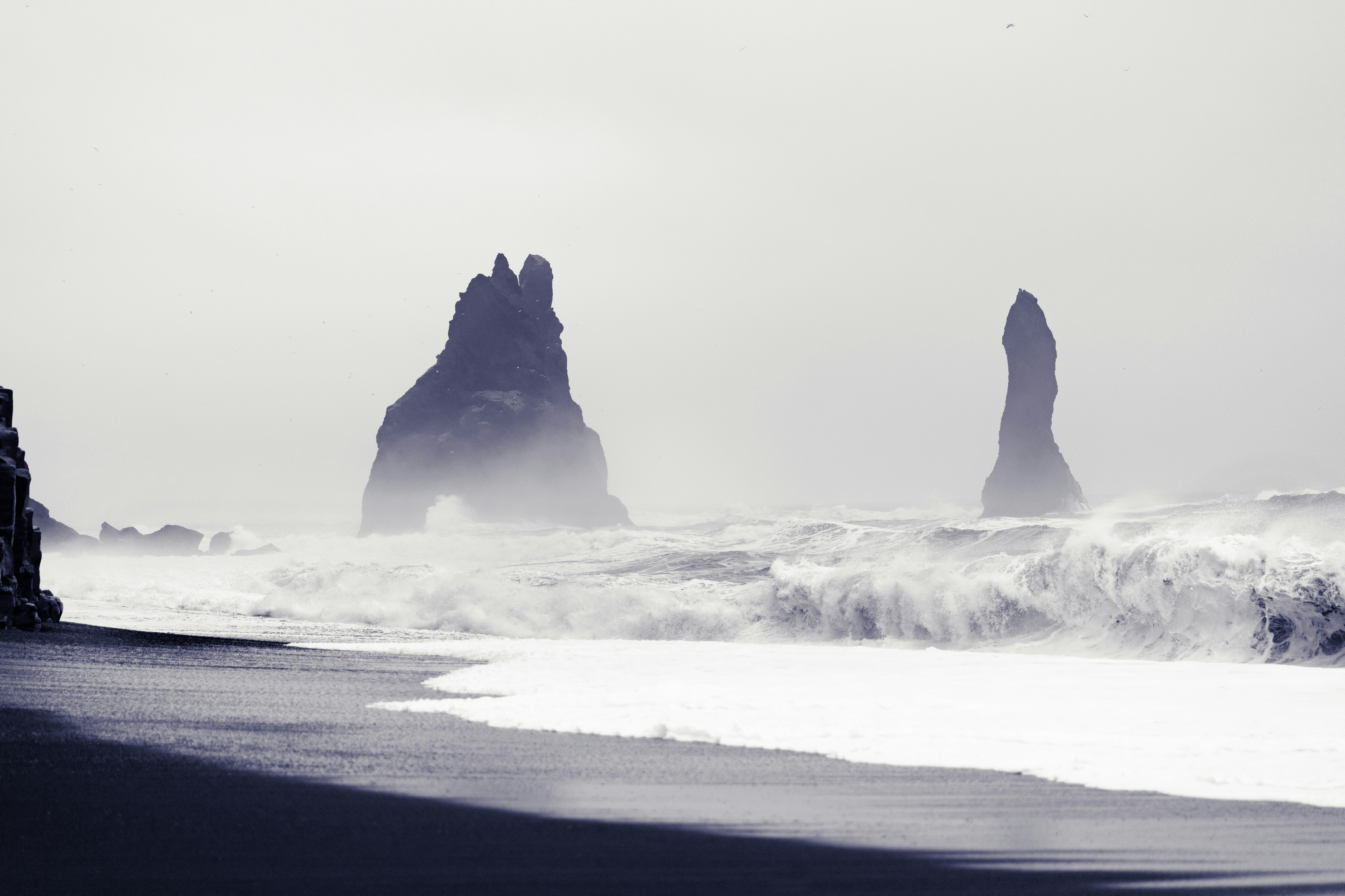 black stone formations in beach